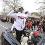 
              Georgia defensive tackle Jordan Davis reacts to the crowd by showing his support for the Atlanta Braves during the NCAA college football champions victory parade through the school campus in Athens, Ga., Saturday, Jan. 15, 2022. (Miguel Martinez/Atlanta Journal-Constitution via AP)
            