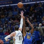 
              Golden State Warriors forward Andrew Wiggins (22) shoots against New Orleans Pelicans center Jonas Valanciunas (17) in the first half of an NBA basketball game in New Orleans, Thursday, Jan. 6, 2022. (AP Photo/Gerald Herbert)
            