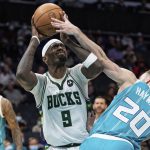 
              Milwaukee Bucks center Bobby Portis (9) tries to shoot while guarded by Charlotte Hornets forward Gordon Hayward (20) during the first half of an NBA basketball game in Charlotte, N.C., Monday, Jan. 10, 2022. (AP Photo/Jacob Kupferman)
            