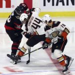 
              Ottawa Senators' Austin Watson (16) battles with Anaheim Ducks' Max Comtois (44) as Ducks' Troy Terry (19) looks on during the first period of an NHL hockey game in Ottawa, Saturday, Jan. 29, 2022. (Fred Chartrand/The Canadian Press via AP)
            