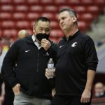 
              Washington State athletic director Pat Chun, left, speaks with head coach Kyle Smith during a delay before an NCAA college basketball game against Stanford, Thursday, Jan. 13, 2022, in Pullman, Wash. (AP Photo/Young Kwak)
            