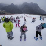 
              School children warm up before ski lessons at the Vanke Shijinglong Ski Resort in Yanqing on the outskirts of Beijing, China, Thursday, Dec. 23, 2021. The Beijing Winter Olympics is tapping into and encouraging growing interest among Chinese in skiing, skating, hockey and other previously unfamiliar winter sports. It's also creating new business opportunities. (AP Photo/Ng Han Guan)
            