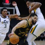 
              Toronto Raptors guard Fred VanVleet (23) drives against Utah Jazz center Hassan Whiteside (21) as guard Trent Forrest (3) watches during the second half of an NBA basketball game Friday, Jan. 7, 2022, in Toronto. (Frank Gunn/The Canadian Press via AP)
            