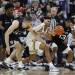 
              Providence forward Justin Minaya (15) loses control of the ball as Butler forward Bryce Golden (33) and guard Jayden Taylor (13) defend during the second half of an NCAA college basketball game, Sunday, Jan. 23, 2022, in Providence, R.I. (AP Photo/Mary Schwalm)
            