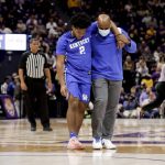 
              Kentucky guard Sahvir Wheeler (2) is assisted off the court after getting injured in the first half of an NCAA college basketball game against LSU in Baton Rouge, La., Tuesday, Jan. 4, 2022. (AP Photo/Derick Hingle)
            