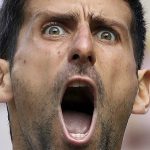 
              FILE - Serbia's Novak Djokovic celebrates winning a point against Spain's Roberto Bautista Agut in a Men's singles semifinal match on day eleven of the Wimbledon Tennis Championships in London on July 12, 2019. (Carl Recine/Pool Photo via AP, File)
            