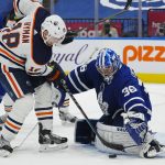 
              Toronto Maple Leafs goaltender Jack Campbell (36) makes a save on Edmonton Oilers' Zach Hyman (18) during the third period of an NHL hockey game, Wednesday, Jan. 5, 2022 in Toronto. (Frank Gunn/The Canadian Press via AP)
            