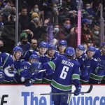 
              Vancouver Canucks' Brock Boeser (6) is congratulated for his shootout goal against the Florida Panthers in an NHL hockey game Friday, Jan. 21, 2022, in Vancouver, British Columbia. (Darryl Dyck/The Canadian Press via AP)
            