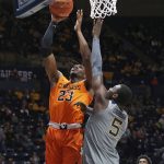 
              Oklahoma State forward Tyreek Smith (23) shoots while defended by West Virginia forward Dimon Carrigan (5) during the first half of an NCAA college basketball game in Morgantown, W.Va., Tuesday, Jan. 11, 2022. (AP Photo/Kathleen Batten)
            