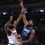 
              Minnesota Timberwolves center Karl-Anthony Towns (32) shoots over New York Knicks center Mitchell Robinson (23) during the first half of an NBA basketball game, Tuesday, Jan. 18, 2022 in New York. (AP Photo/Noah K. Murray)
            
