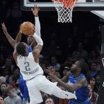 
              Oklahoma City Thunder guard Shai Gilgeous-Alexander (2) is defended by Minnesota Timberwolves forwards Anthony Edwards, back left, and Taurean Prince, right, in the first half of an NBA basketball game Friday, Jan. 7, 2022, in Oklahoma City. (AP Photo/Sue Ogrocki)
            