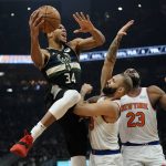 
              Milwaukee Bucks' Giannis Antetokounmpo is fouled by New York Knicks' Evan Fournier during the first half of an NBA basketball game Friday, Jan. 28, 2022, in Milwaukee. (AP Photo/Morry Gash)
            