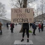 
              Demonstrator holds a placard that reads 'No to vaccine pass' in opposition to vaccine pass and vaccinations to protect against COVID-19 during a rally in Paris, France, Saturday, Jan. 22, 2022. (AP Photo/Rafael Yaghobzadeh)
            