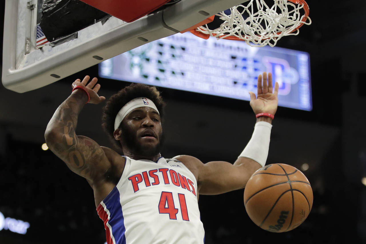 Detroit Pistons' Saddiq Bey dunks during the first half of an NBA basketball game against the Milwa...