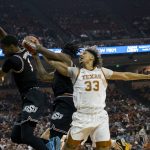 
              Texas forward Tre Mitchell, right, goes up for a rebound against Oklahoma State guard Issac Likekele, center, and guard Bryce Thompson, left, during the first half of an NCAA college basketball game, Saturday, Jan. 22, 2022, in Austin, Texas. (AP Photo/Michael Thomas)
            