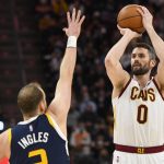 
              Cleveland Cavaliers forward Kevin Love (0) shoots over Utah Jazz guard Joe Ingles, left, during the first half of an NBA basketball game Wednesday, Jan. 12, 2022, in Salt Lake City. (AP Photo/Alex Goodlett)
            