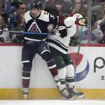 
              Colorado Avalanche left wing J.T. Compher, left, checks Minnesota Wild left wing Kevin Fiala in the first period of an NHL hockey game Monday, Jan. 17, 2022, in Denver. (AP Photo/David Zalubowski)
            