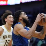 
              Minnesota Timberwolves center Karl-Anthony Towns (32) goes to the basket against New Orleans Pelicans center Jaxson Hayes (10) in the first half of an NBA basketball game in New Orleans, Tuesday, Jan. 11, 2022. (AP Photo/Gerald Herbert)
            