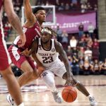 
              Texas A&M guard Tyrece Radford (23) drives the lane against Arkansas guard Au'Diese Toney (5) during the second half of an NCAA college basketball game Saturday, Jan. 8, 2022, in College Station, Texas. (AP Photo/Sam Craft)
            