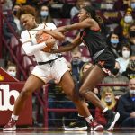 
              Minnesota guard Alexia Smith, left and Maryland guard Diamond Miller hang on for a jump ball call during the first half an NCAA college basketball game Sunday Jan. 9, 2022, in Minneapolis. (AP Photo/Craig Lassig)
            
