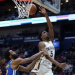 
              New Orleans Pelicans forward Herbert Jones (5) goes to the basket over Golden State Warriors forward Andrew Wiggins (22) in the second half of an NBA basketball game in New Orleans, Thursday, Jan. 6, 2022. The Pelicans won 101-96. (AP Photo/Gerald Herbert)
            
