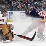 
              Chicago Blackhawks' Marc-Andre Fleury, left, makes a save against Columbus Blue Jackets' Boone Jenner during the second period of an NHL hockey game Tuesday, Jan. 11, 2022, in Columbus, Ohio. (AP Photo/Jay LaPrete)
            