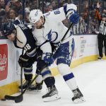 
              Columbus Blue Jackets' Boone Jenner, left, and Tampa Bay Lightning's Erik Cernak fight for a loose puck during the second period of an NHL hockey game Tuesday, Jan. 4, 2022, in Columbus, Ohio. (AP Photo/Jay LaPrete)
            