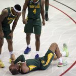 
              Baylor forward Jeremy Sochan, bottom, covers his face after getting injured on a play in the first half of an NCAA college basketball game against TCU in Fort Worth, Texas, Saturday, Jan. 8, 2022. (AP Photo/Emil Lippe)
            