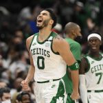 
              Boston Celtics forward Jayson Tatum (0) reacts after making a three-point basket during the second half of an NBA basketball game against the Washington Wizards, Sunday, Jan. 23, 2022, in Washington. (AP Photo/Nick Wass)
            