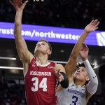 
              Wisconsin guard Brad Davison, left, shoots past Northwestern guard Ty Berry during the first half of an NCAA college basketball game in Evanston, Ill., Tuesday, Jan. 18, 2022. (AP Photo/Nam Y. Huh)
            