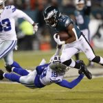 
              Dallas Cowboys free safety Damontae Kazee (18) trips up Philadelphia Eagles running back Jason Huntley (32) up during the first half of an NFL football game, Saturday, Jan. 8, 2022, in Philadelphia. (AP Photo/Laurence Kesterson)
            