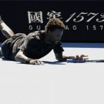 
              Gael Monfils of France falls during his third round match against Cristian Garin of Chile at the Australian Open tennis championships in Melbourne, Australia, Friday, Jan. 21, 2022. (AP Photo/Hamish Blair)
            