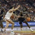 
              Oklahoma State guard Issac Likekele, right, drives the ball against Texas forward Timmy Allen, left, during the first half of an NCAA college basketball game, Saturday, Jan. 22, 2022, in Austin, Texas. (AP Photo/Michael Thomas)
            