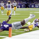 
              Kansas State wide receiver Malik Knowles (4) gets the ball into the end zone to score past LSU defensive back Damarius McGhee (26) during the first half of the Texas Bowl NCAA college football game Tuesday, Jan. 4, 2022, in Houston. (AP Photo/Michael Wyke)
            