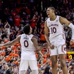 
              Auburn guard K.D. Johnson (0) and forward Jabari Smith (10) celebrate after defeating LSU during the second half of an NCAA college basketball game Wednesday, Dec. 29, 2021, in Auburn, Ala. (AP Photo/Butch Dill)
            