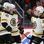 
              Boston Bruins center Craig Smith, center, celebrates his goal with left wing Anton Blidh (81) and center Curtis Lazar (20) during the second period of an NHL hockey game against the Washington Capitals, Monday, Jan. 10, 2022, in Washington. (AP Photo/Nick Wass)
            