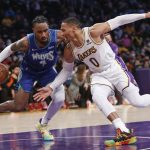 
              Los Angeles Lakers guard Russell Westbrook (0) tries to reach the ball controlled by Minnesota Timberwolves guard Jaylen Nowell (4) during the first half of an NBA basketball game in Los Angeles, Sunday, Jan. 2, 2022. (AP Photo/Ringo H.W. Chiu)
            