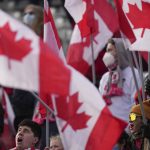 
              Canada fans cheer as the team plays against the United States during the first half of a World Cup soccer qualifier in Hamilton, Ontario, Sunday, Jan. 30, 2022. (Nathan Denette/The Canadian Press via AP)
            