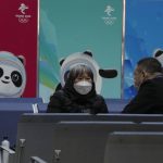 
              Passengers wearing masks to protect from the coronavirus sit near Beijing Winter Olympics posters at the South Train Station in Beijing, China, Friday, Jan. 14, 2022. As the Beijing Winter Olympics loom, the Chinese capital is stepping measures to keep the coronavirus at bay including suspending most access to Tianjin, an adjacent major city which is dealing with an outbreak of the highly contagious omicron variant. These outbreaks are posing a test to its "zero-tolerance" COVID-19 policy and its ability to successfully host the Winter Olympics. (AP Photo/Ng Han Guan)
            