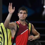 
              Carlos Alcaraz of Spain waves as he leaves Rod Laver Arena following his third round loss to Matteo Berrettini of Italy at the Australian Open tennis championships in Melbourne, Australia, Friday, Jan. 21, 2022. (AP Photo/Andy Brownbill)
            