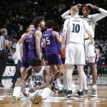 
              Michigan State and Northwestern players, including Michigan State's Julius Marble, Joey Hauser (10) and Marcus Bingham Jr., right, and Northwestern's Ryan Greer, left, Boo Buie (0) and Julian Roper II (5), react as time expires in an NCAA college basketball game, Saturday, Jan. 15, 2022, in East Lansing, Mich. Northwestern won 64-62. (AP Photo/Al Goldis)
            