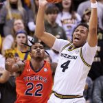 
              Missouri's Javon Pickett, right, grabs a rebound in front of Auburn's Allen Flanigan, left, during the first half of an NCAA college basketball game Tuesday, Jan. 25, 2022, in Columbia, Mo. (AP Photo/L.G. Patterson)
            