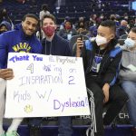 
              Golden State Warriors guard Gary Payton II, left, greets young fans from the group Decoding Dyslexia CA, before the team's NBA basketball game against the Detroit Pistons in San Francisco, Tuesday, Jan. 18, 2022. Payton spoke to the group recently. (AP Photo/Jed Jacobsohn)
            