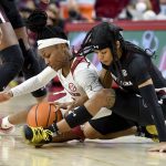 
              Arkansas guard Makayla Daniels (43) and South Carolina guard Destanni Henderson (3) fight for the ball during the second half of an NCAA college basketball game Sunday, Jan. 16, 2022, in Fayetteville, Ark. (AP Photo/Michael Woods)
            