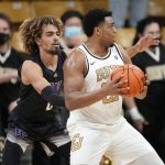 
              Colorado forward Evan Battey, front, looks to drive the lane as Washington forward Emmitt Matthews Jr. defends in the first first half of an NCAA college basketball game Sunday, Jan. 9, 2022, in Boulder, Colo. (AP Photo/David Zalubowski)
            