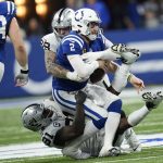 
              Indianapolis Colts quarterback Carson Wentz (2) is sacked by Las Vegas Raiders defensive end Yannick Ngakoue (91) and defensive end Maxx Crosby (98) during the second half of an NFL football game, Sunday, Jan. 2, 2022, in Indianapolis. (AP Photo/AJ Mast)
            