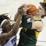 
              From left, TCU forward Xavier Cork (12) and Baylor guard Matthew Mayer (24) battle for a rebound in the first half of an NCAA college basketball game in Fort Worth, Texas, Saturday, Jan. 8, 2022. (AP Photo/Emil Lippe)
            