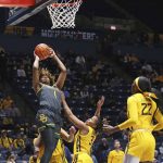 
              Baylor forward NaLyssa Smith (1) shoots while defended by West Virginia guard Kirsten Deans (3) during the first half of an NCAA college basketball game in Morgantown, W.Va., Saturday, Jan. 29, 2022. (AP Photo/Kathleen Batten)
            