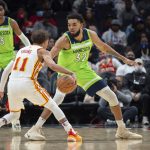 
              Atlanta Hawks guard Trae Young (11) dribbles the ball in front of Minnesota Timberwolves center Karl-Anthony Towns (32) during the second half of an NBA basketball game Wednesday, Jan. 19, 2022, in Atlanta. (AP Photo/Hakim Wright Sr.)
            