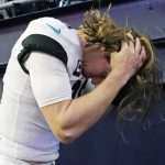 
              Jacksonville Jaguars quarterback Trevor Lawrence scratches his head while heading to the locker room after a 50-10 loss to the New England Patriots after an NFL football game, Sunday, Jan. 2, 2022, in Foxborough, Mass. (AP Photo/Steven Senne)
            